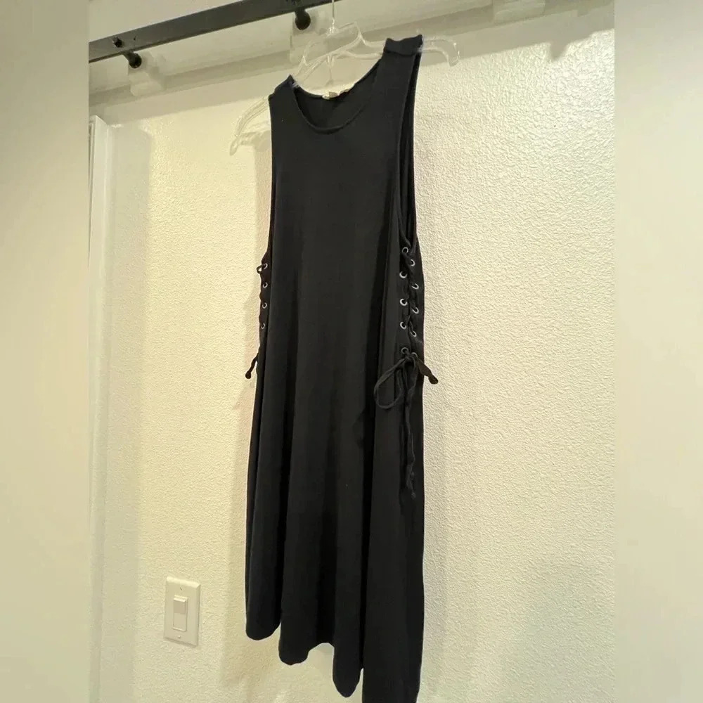 Super cute black swing dress, side ties with grommets.​